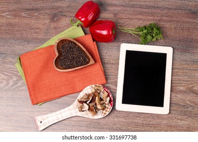 Vegetables on old wooden background  with digital tablet behind - Powered by Shutterstock