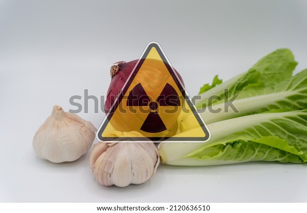 vegetables with radiation\
warnings.contaminated foods.Radioactive soil.metaphor for nuclear\
threat.Nuclear leak,Environmental damage.white\
background.