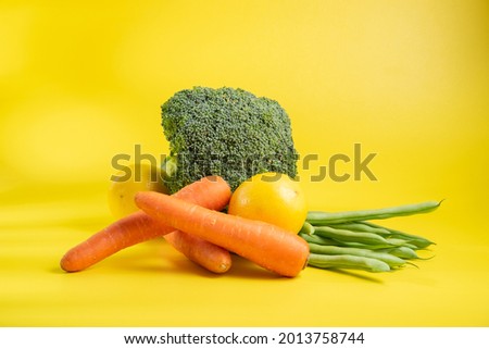 Vegetables in Rattan basket on yellow background