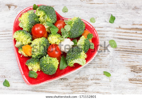 Vegetables. Raw vegetable in heart shaped plate. Diet\
concept. Macrobiotic.\
