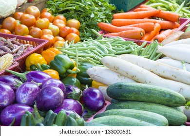 Vegetables Stand In Wet Market In Asia With Cucumbers Tomatoes Carrots Beans Eggplant Radish