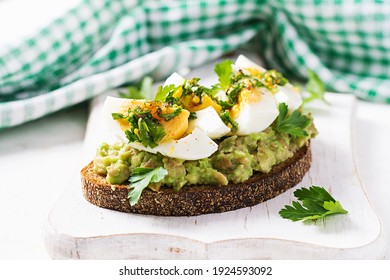 Vegetarian breakfast. Sandwich with avocado puree and boiled eggs.  Healthy breakfast or lunch.