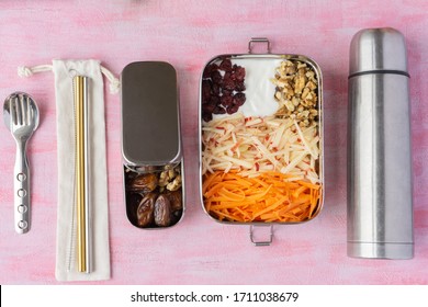 Vegetarian Carrot And Apple Salad In Big Stainless Steel Food Container. Dry Dates In Small Plastic Free Lunch Box. Metal Straws, Spoon, Fork, And Thermos Near It. Zero Waste, Eco Friendly.