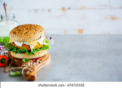 Vegetarian Carrot And Oats Burger With Cheese, Wholegrain Buns On Wooden Board Over Stone Table. White Background, Selective Focus, Copy Space.