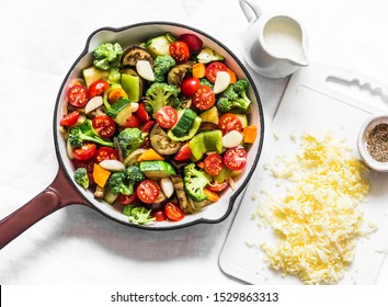 Vegetarian casserole ratatouille, baked in a frying pan on a light background, top view             