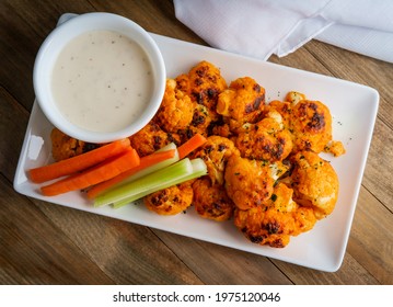 Vegetarian Cauliflower Buffalo Wings Served With Blue Cheese Dipping Sauce And Sliced Carrots And Celery