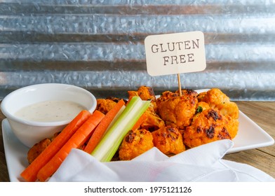 Vegetarian Cauliflower Buffalo Wings Served With Blue Cheese Dipping Sauce And Sliced Carrots And Celery