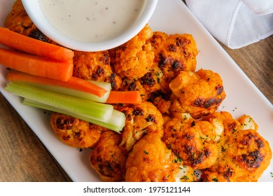 Vegetarian Cauliflower Buffalo Wings Served With Blue Cheese Dipping Sauce And Sliced Carrots And Celery