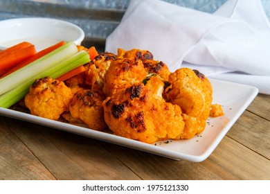 Vegetarian Cauliflower Buffalo Wings Served With Blue Cheese Dipping Sauce And Sliced Carrots And Celery