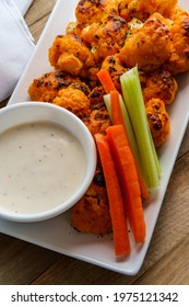 Vegetarian Cauliflower Buffalo Wings Served With Blue Cheese Dipping Sauce And Sliced Carrots And Celery