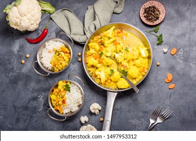 Vegetarian Curry With Cauliflower And Chickpeas Served In Metal Bowls With Rice, Healthy Homemade Vegan Food, Indian Cuisine, Clean Eating Concept,