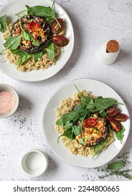 Vegetarian dinner. Quinoa cereal with stuffed mushroom, gratin cheese, cherry tomatoes and baby spinach leaves. - Shutterstock ID 2244800665