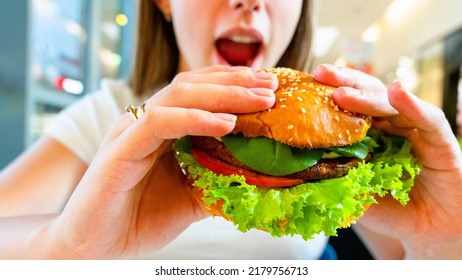 Vegetarian Hamburger Healthy Vegan Burger. Cute Cheerful Girl Eating Veggie Sandwich With Salad, Avocado, Vegetable. Vegan Burger Healthy Diet Food