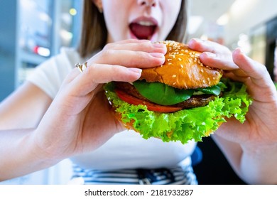 Vegetarian Hamburger Healthy Vegan Burger. Cute Cheerful Girl Eating Veggie Sandwich With Salad, Avocado, Vegetable. Vegan Burger Healthy Diet Food