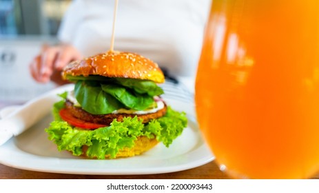 Vegetarian Hamburger Healthy Vegan Burger. Cute Cheerful Girl Eating Veggie Sandwich With Salad, Avocado, Vegetable. Vegan Burger Healthy Diet Food