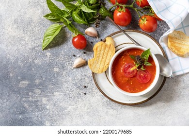 Vegetarian Healthy Diet. Vegan Soup Puree Tomatoes. Bowl Of Tomato Cream Soup With Basil And Croutons On A Stone Table. View From Above. Copy Space.
