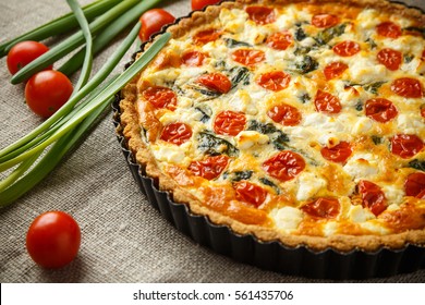 Vegetarian homemade pie, Quiche with tomatoes, spinach and feta cheese
