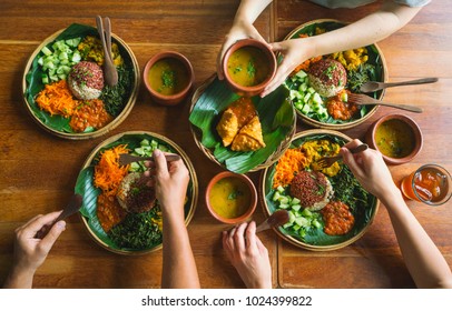 Vegetarian Indian Food. Several People Eat Indian Food At A Common Table Together, A View From Above.