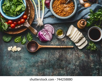 Vegetarian Ingredients For Tasty Lentil Dishes On Rustic Kitchen Table Background With Cooking Spoon And Utensils, Top View, Border. Healthy Eating And Cooking, Clean Or Diet Food Concept