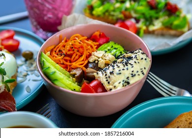 Vegetarian Lunch In Cafe.Healthy Vegan Breakfast Meal Served On Table In Restaurant.Delicious Hawaiian Poke Bowl Dish With Fresh Vegetables & Hummus Dip For Keto Diet.Enjoy Tasty Raw Foods 