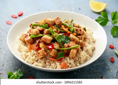 Vegetarian Meat Free Mycoprotein Pieces Vegetable Stir Fry, Brown Rice Served In White Plate