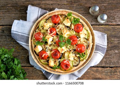 Vegetarian Pie With Zucchini And Grilled Eggplant, Cherry Tomatoes, Hard Cheese And Cream Cheese.