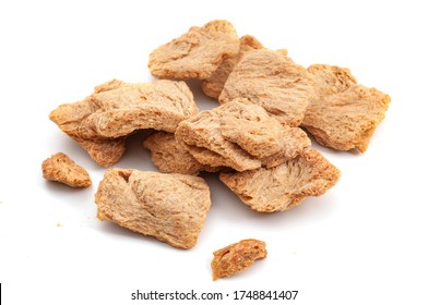 Vegetarian Protein Source Vegan Alternative To Meats And Biotechnology Concept With Group Of Raw Dehydrated Soy Meat Or Soya Textured Chunks Isolated On White Background