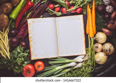 Vegetarian Raw Food Recipe. Blank Empty Cook Book Mockup with Fresh Vegetables. Healthy Eating Concept with Copy Space.