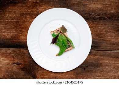 Vegetarian Sandwich Half Eaten. Toast With A Creamy Spread And Assorted Edible Salad Leaves. White Plate, Dark Wooden Background. Healthy Eating. Food Concept.