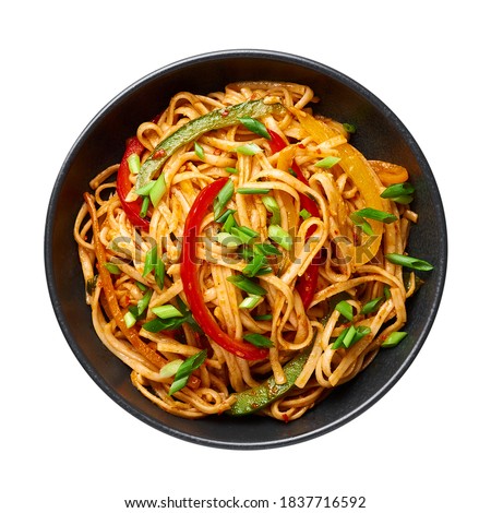 Vegetarian Schezwan Noodles or Vegetable Hakka Noodles or Chow Mein isolated on white background. Schezwan Noodles is indo-chinese cuisine hot dish with udon noodles, vegetables and chilli sauce