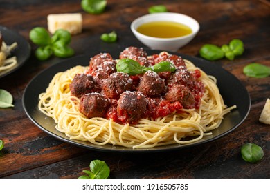 Vegetarian spaghetti with meat free, vegan meatballs in rich tomato sauce, grated cheese and basil leaves