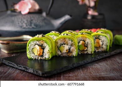 Vegetarian sushi rolls avocado with cream Philadelphia cheese, sesame, unagi sauce. Sushi menu. Japanese food.  - Powered by Shutterstock