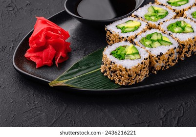 vegetarian sushi rolls on black plate - Powered by Shutterstock