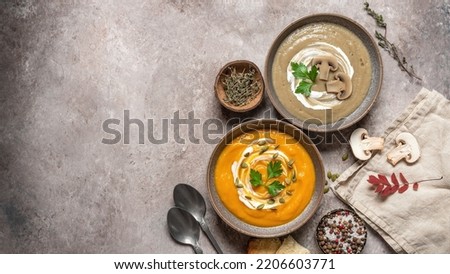 Vegetarian vegetable cream soup. Pumpkin and mushroom soup. Winter warming soup. Top view. Banner