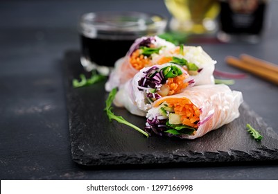 Vegetarian vietnamese spring rolls with spicy sauce, carrot, cucumber, red cabbage and rice noodle. Vegan food. Tasty meal.  Copy space - Shutterstock ID 1297166998