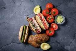 Vegeterian Hot Dogs Served With Tomatoes, Avacado, Onion And Buns Over Stone Grey Background. Top View, Flat Lay