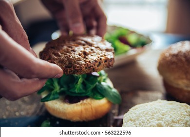 Veggie Burger Being Made On A Wooden Table