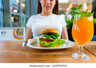 Veggie Burger Healthy Vegan Food. Salad, Avocado, Vegetable On Vegetarian Hamburger Eating Cute Woman. Vegan Sandwich Healthy Diet Food