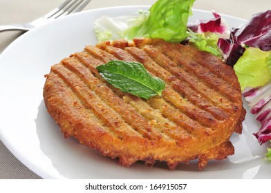 A Veggie Burger In A Plate On A Set Table