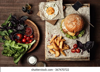 Veggie burger with salad, tomato and fries. Wooden background - Powered by Shutterstock