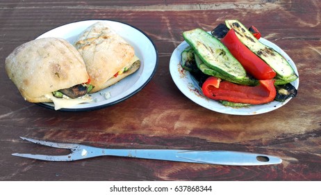 Veggie burgers and roasted vegetables on a wooden background