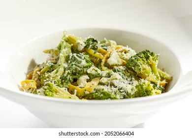 Veggie pasta with broccoli isolated on white background. Vegetarian dish - udon noodle with green vegetables. Vegan food in restaurant menu. Plant based dinning
