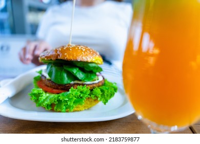 Veggie Sandwich Healthy Vegan Burger. Cute Cheerful Girl Eating Vegetarian Hamburger With Salad, Avocado, Vegetable. Hamburger Vegan Healthy Diet Food