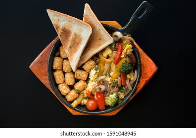 Veggie Skillet. Vegetable Brunch With Toasted Bread,hash Brown,broccoli On Black Background.