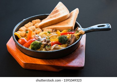 Veggie Skillet. Vegetable Brunch With Toasted Bread,hash Brown,broccoli On Black Background.