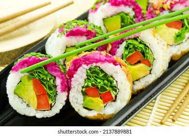 Veggie Sushi California Roll And Chopsticks On Bamboo Background Closeup