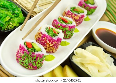 Veggie Sushi California Roll With Ginger, Wasabi, Soya Sauce And Wakame Salad On Bamboo Background 