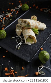 Veggie Wrap with a thin layer of hummus, piled high with your favorite veg, like spinach, edamame, avocado, carrot and cucumbers etc. 