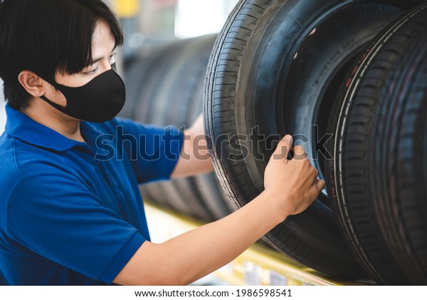 vehicle car tire\
business service automobile, buy and sell auto transport, rubber,\
store sale and repair, client buying in retail garage shop and\
mechanic man change a tyre\
wheel