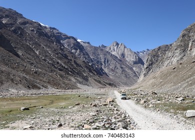 A Vehicle Carrying Tourists On A Treacherous Mountainous Road Among The Rocky Mountains In The Spiti Valley, Himachal Pradesh, India, During The Autumn Season.